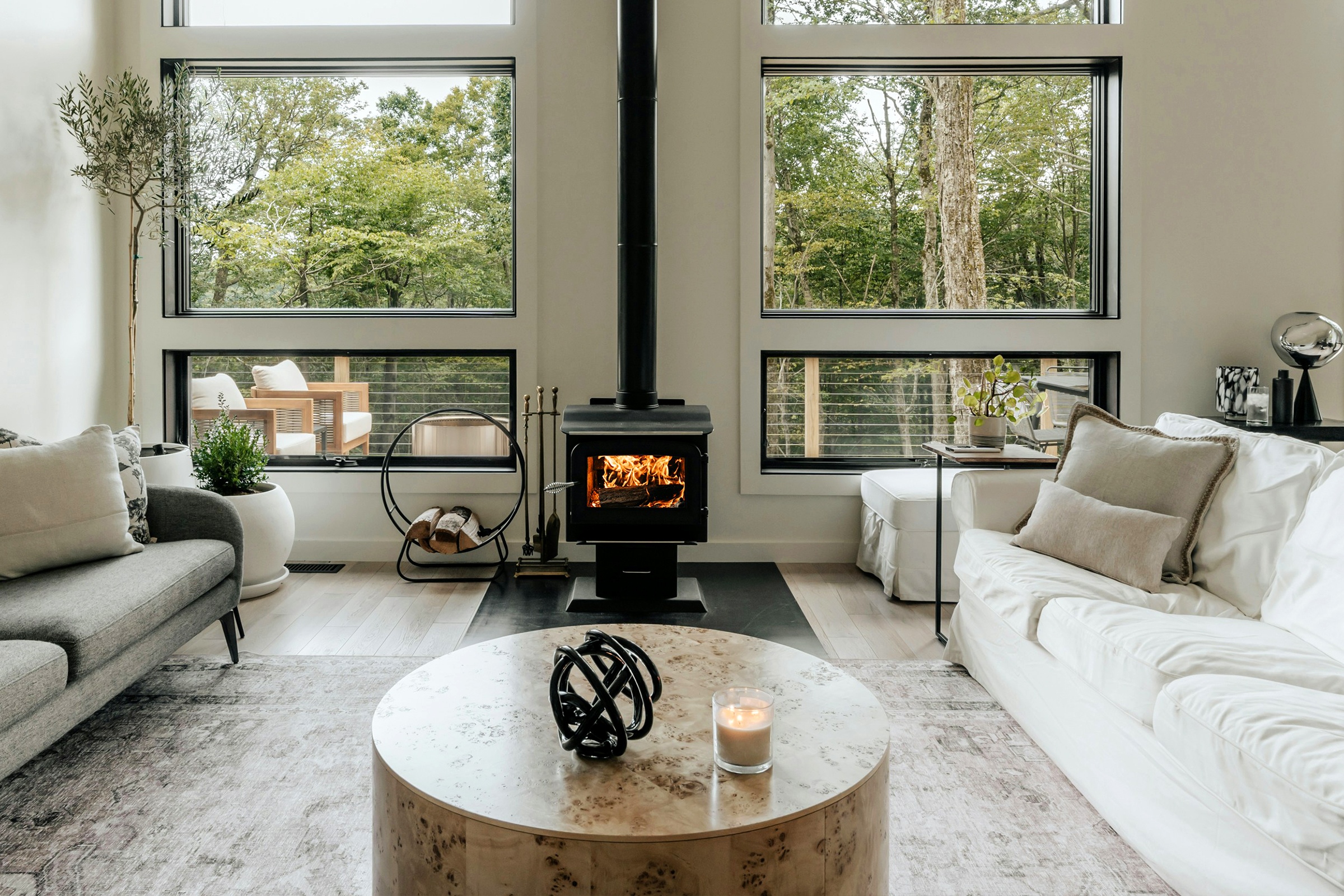 Skantherm Kamin - Herobild _ Wohnzimmer mit großen Fenstern, Kamin in der Mitte
